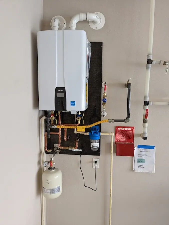 Professional plumber installing copper piping in a Goodyear home